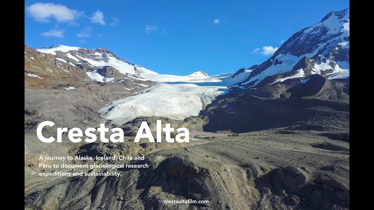 A rugged mountainous landscape with a glacier flowing between rocky peaks under a blue sky. Text reads: “Cresta Alta. A journey to Alaska, Iceland, Chile, and Peru to document glaciological research expeditions and sustainability.”.